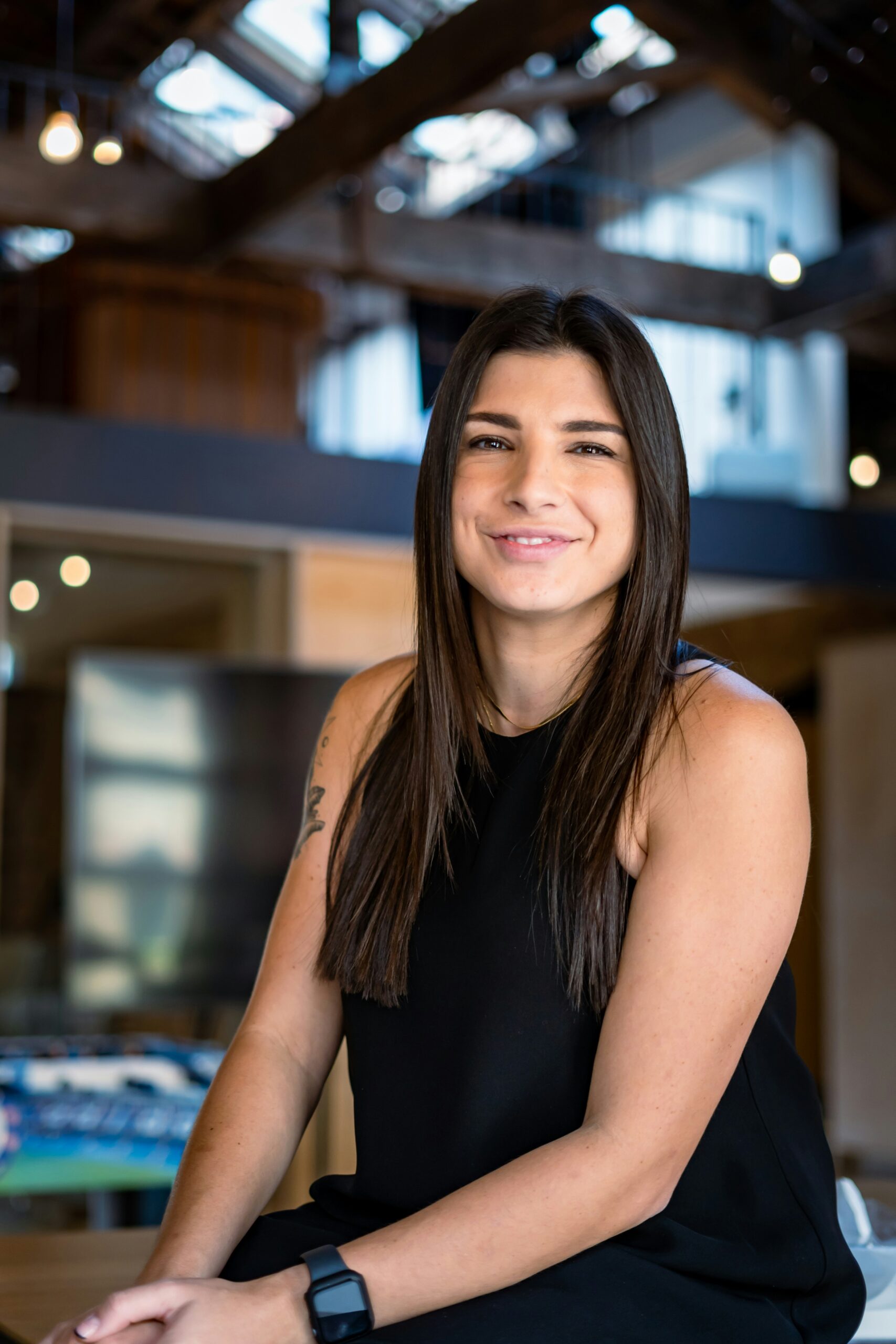 Smiling young woman indoors, representing a successful client of Medical Weight Loss program