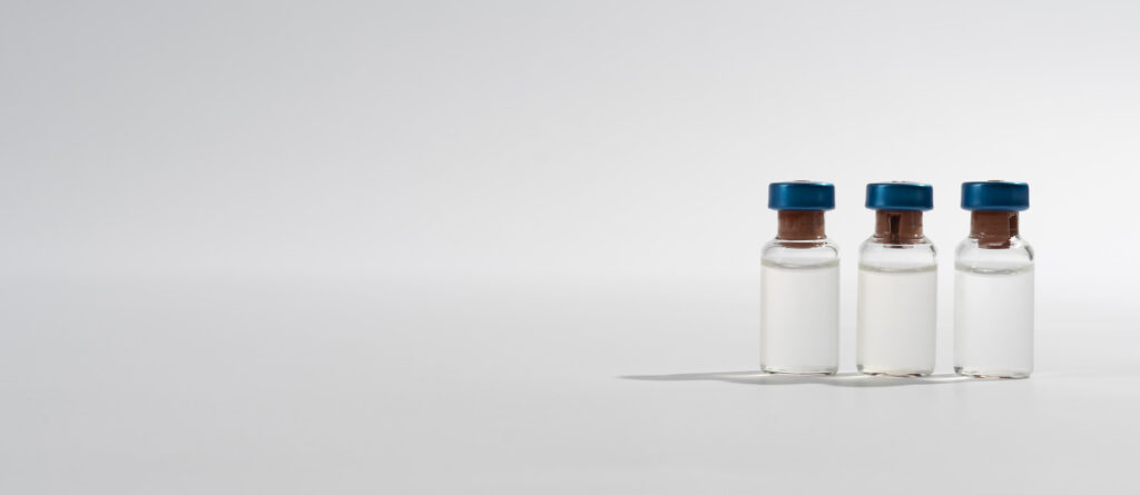 Minimalist medical vials with blue caps, symbolizing science-based medical weight loss treatments
