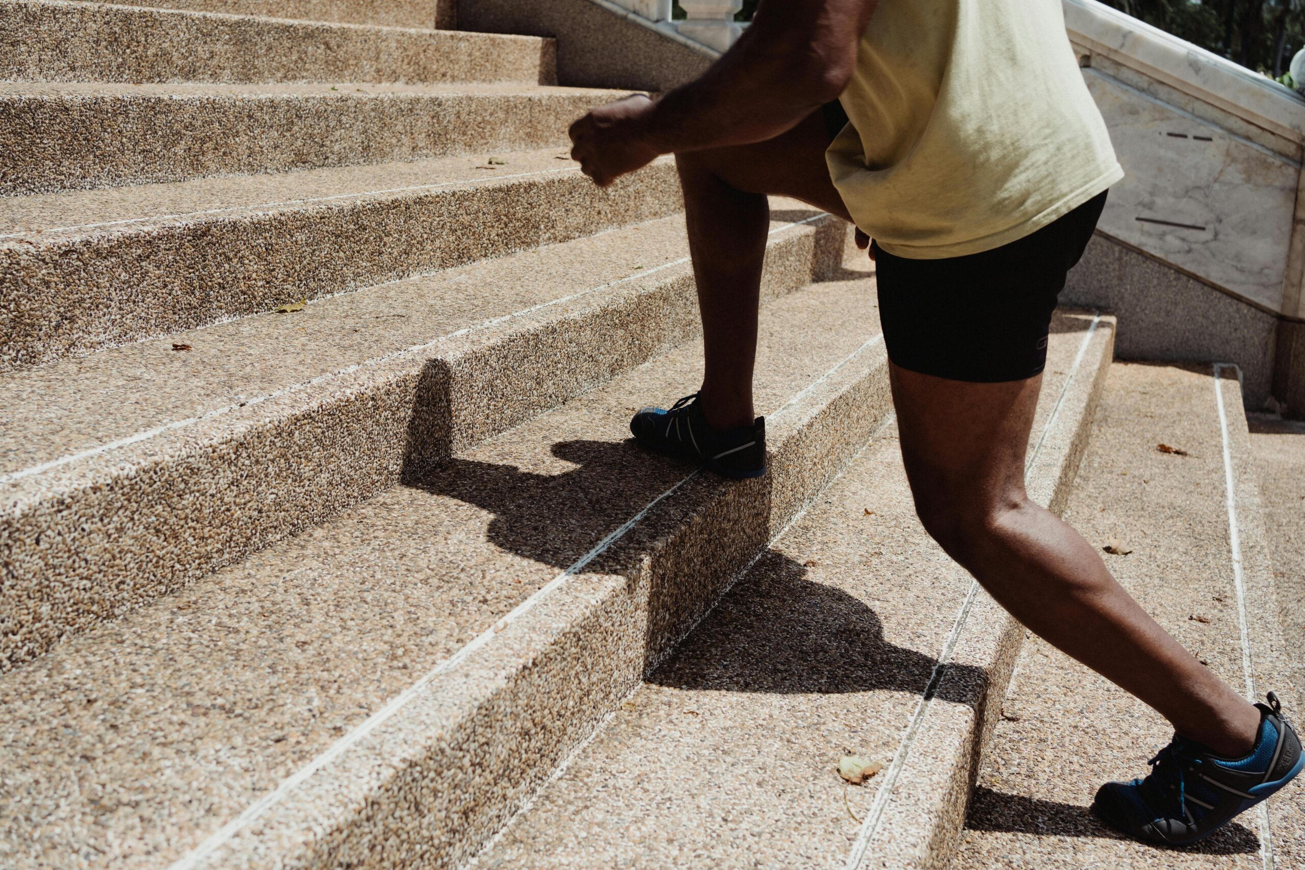 Fitness Training – Man Running Up Stairs Athlete training by running up outdoor stairs