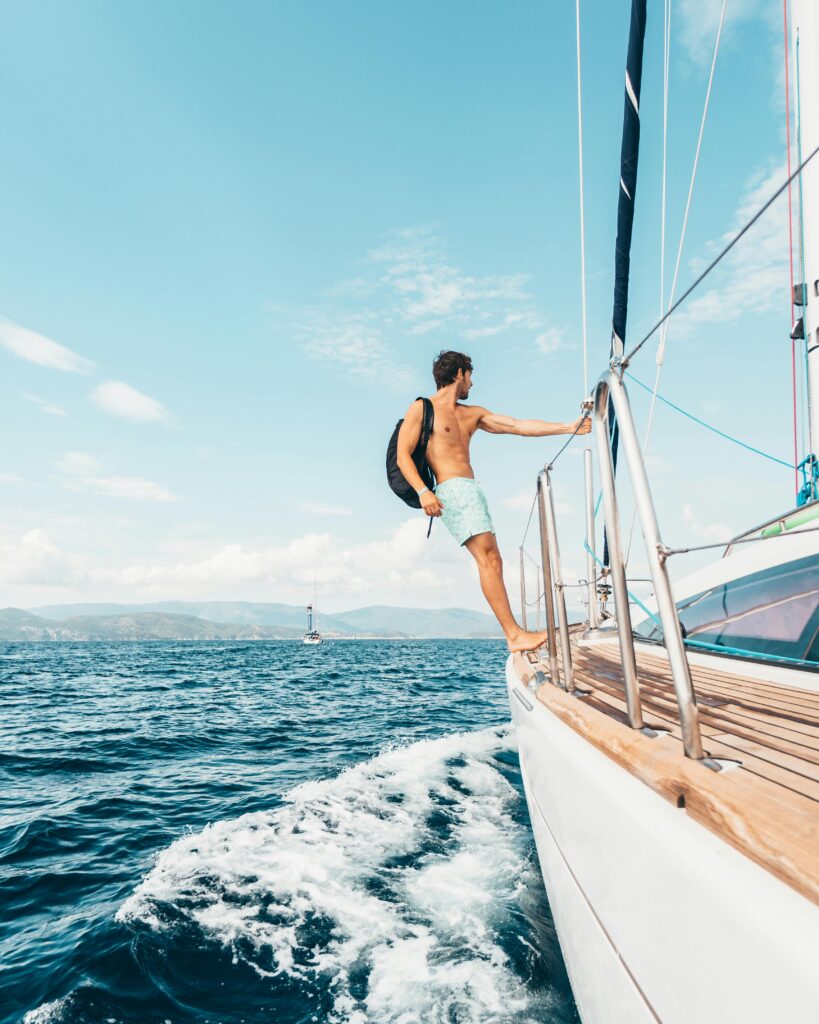 Man enjoying vitality and freedom on a yacht after IV therapy treatment